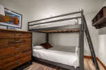 This cozy bedroom features a stylish bunk bed, perfect for accommodating guests or family members.