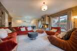 Experience luxury living in this stunning property, featuring a cozy living room with a fireplace and plush seating.