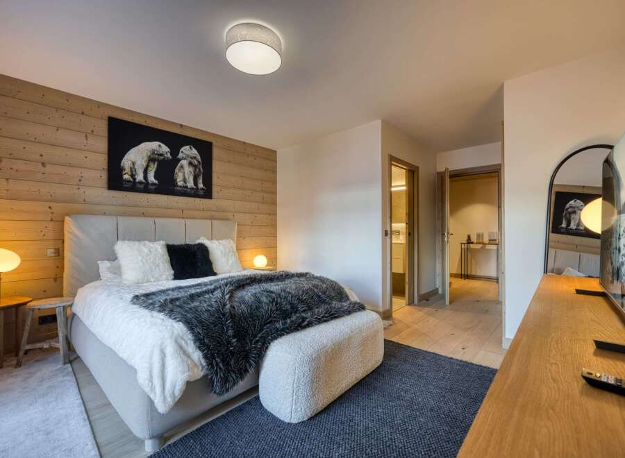 Experience luxury in this stunning bedroom featuring a cozy ambiance.