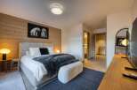 Experience luxury in this stunning bedroom featuring a cozy ambiance.