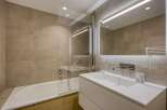 This modern bathroom features a sleek design with neutral tones and high-end finishes.