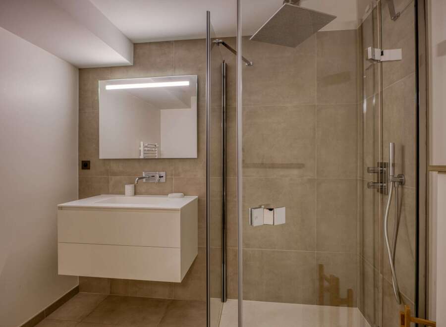 Step into a modern bathroom oasis, featuring sleek design and high-end finishes.