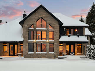This stunning stone-clad home offers a luxurious winter escape.
