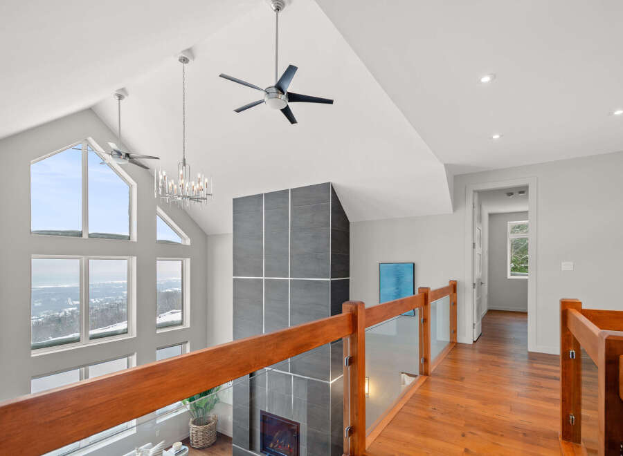 This stunning property boasts a modern interior with high ceilings and expansive windows that flood the space with natural light.