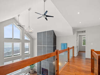 This stunning property boasts a modern interior with high ceilings and expansive windows that flood the space with natural light.