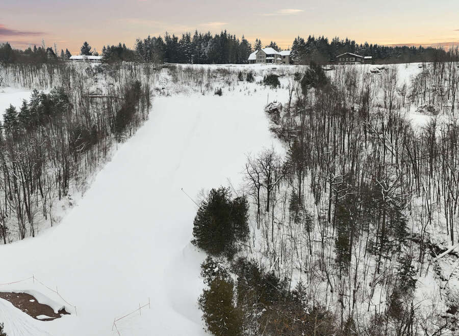 This stunning property offers a serene winter landscape, perfect for those seeking a peaceful retreat.
