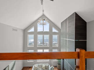 Experience luxury living in this stunning property featuring soaring ceilings and expansive windows that flood the space with natural light.