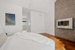 This stunning bedroom boasts a modern fireplace, adding warmth and sophistication to the space.