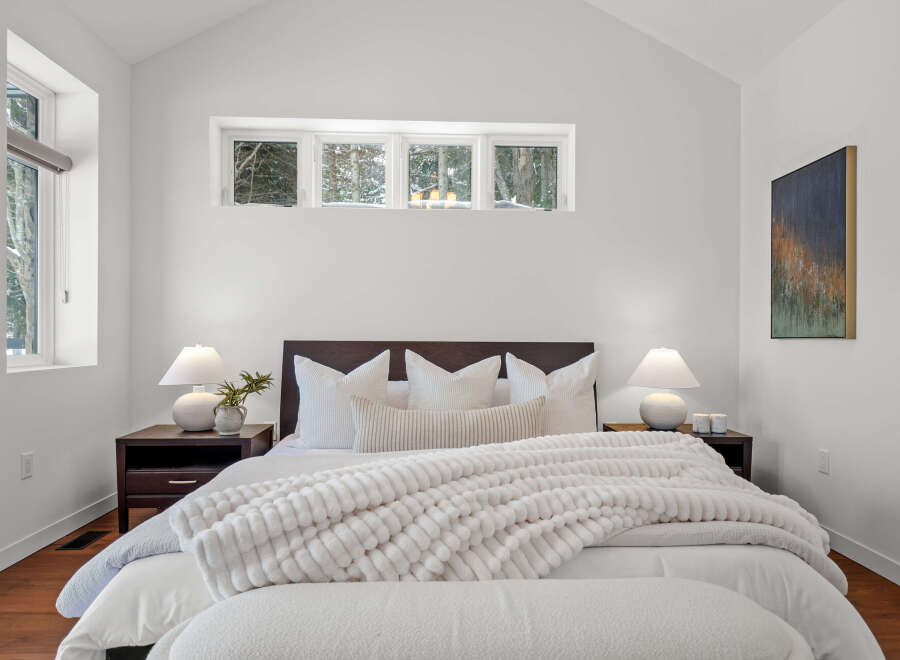 This stunning bedroom boasts a modern design with a cozy atmosphere.