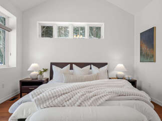 This stunning bedroom boasts a modern design with a cozy atmosphere.