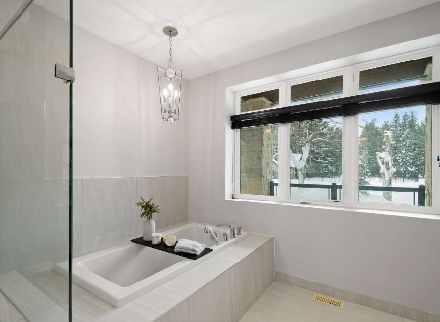 This luxurious bathroom boasts a spa-like ambiance with its sleek design and high-end finishes.