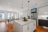 This stunning kitchen boasts a modern design with a spacious island, perfect for meal preparation and entertaining.