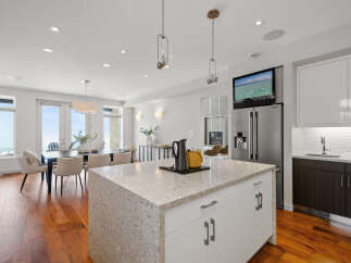 This stunning kitchen boasts a modern design with a spacious island, perfect for meal preparation and entertaining.