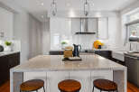This stunning kitchen boasts a modern design with sleek white cabinetry and a spacious island, perfect for entertaining.