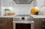 This modern kitchen boasts sleek stainless steel appliances, including a stylish oven with a digital display.