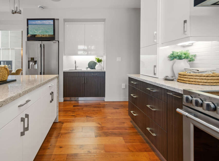 This modern kitchen boasts sleek cabinetry, granite countertops, and stainless steel appliances, creating a stylish and functional space.