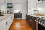 This modern kitchen boasts sleek cabinetry, granite countertops, and stainless steel appliances, creating a stylish and functional space.