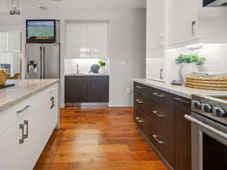 This modern kitchen boasts sleek cabinetry, granite countertops, and stainless steel appliances, creating a stylish and functional space.