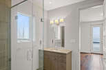 Step into luxury with this stunning bathroom featuring a sleek glass shower enclosure and a modern vanity.