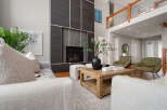 Step into luxury with this stunning living room, featuring a modern fireplace and stylish seating.