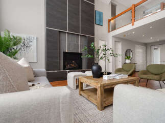 Step into luxury with this stunning living room, featuring a modern fireplace and stylish seating.