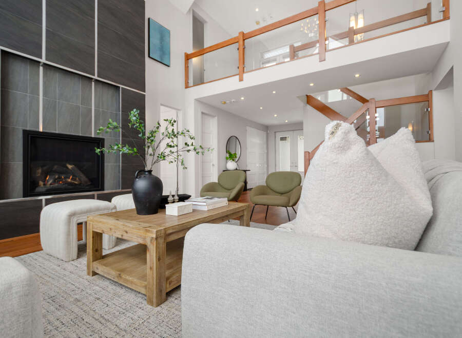 Step into luxury with this stunning property, featuring a modern fireplace and a cozy living area.