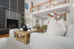 Step into luxury with this stunning property, featuring a modern fireplace and a cozy living area.