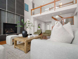 Step into luxury with this stunning property, featuring a modern fireplace and a cozy living area.