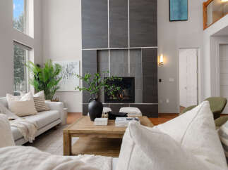 Step into luxury with this stunning living room, featuring a modern fireplace and elegant design.