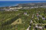 Experience luxury living in this stunning estate, nestled amidst lush greenery with breathtaking views of the distant ocean.