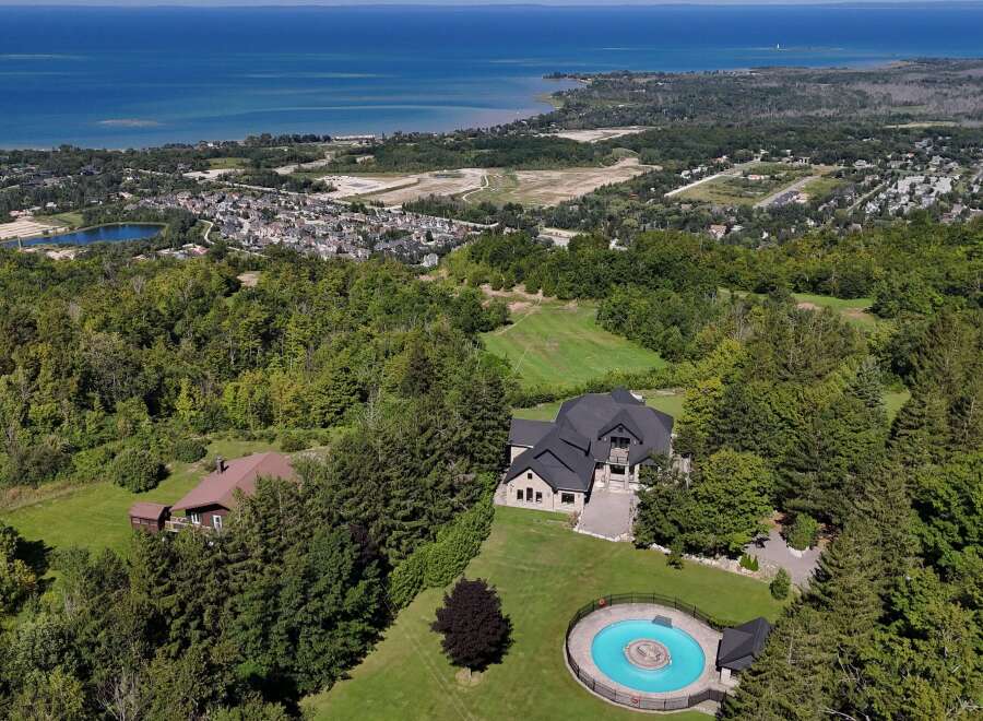 Experience luxury living in this stunning estate, featuring a modern architectural masterpiece with a grand entrance and expansive living spaces.