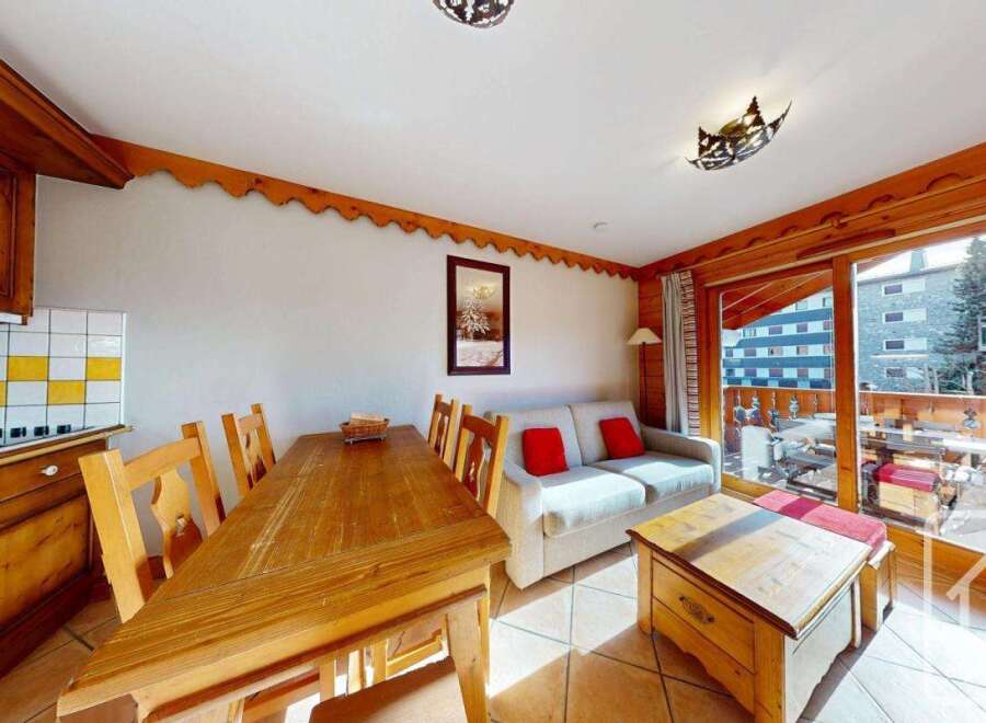 This charming property features a cozy living space with a dining area and a comfortable sofa.