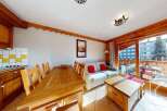 This charming property features a cozy living space with a dining area and a comfortable sofa.