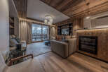 Experience luxury living in this stunning property featuring a cozy living room with a fireplace and a modern entertainment system.