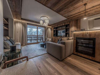 Experience luxury living in this stunning property featuring a cozy living room with a fireplace and a modern entertainment system.