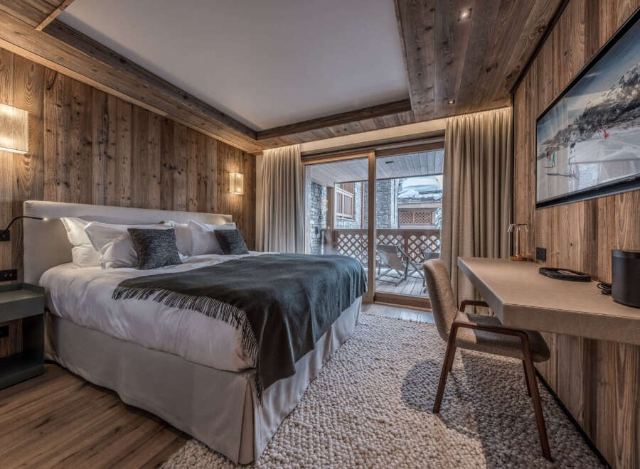 Experience luxury in this stunning bedroom featuring exquisite wood paneling and a cozy ambiance.