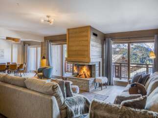 Experience the epitome of luxury in this stunning property, featuring a cozy living room with a fireplace, perfect for those chilly evenings.
