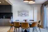This stunning dining area features a modern design with a touch of warmth.