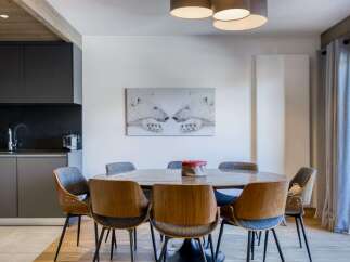 This stunning dining area features a modern design with a touch of warmth.