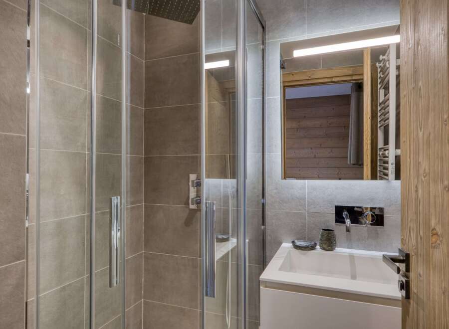 Step into a modern bathroom with a sleek glass shower enclosure.