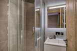 Step into a modern bathroom with a sleek glass shower enclosure.
