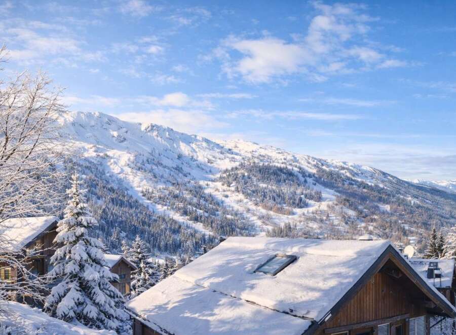 Nestled in a picturesque winter wonderland, this charming property offers stunning mountain views.