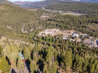 This stunning property offers breathtaking views of the surrounding mountains and lush forests.