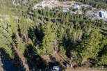 An aerial view showcases a lush, forested landscape, potentially indicating a property with significant natural surroundings.