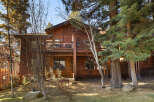 Nestled amidst towering trees, this stunning wooden cabin offers a serene escape.