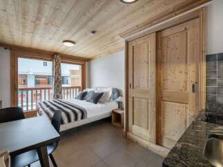 Discover the charm of this cozy apartment, featuring a beautifully designed bedroom with a comfortable bed and stylish decor.