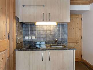 Discover the charm of this cozy kitchen, perfect for preparing delicious meals.