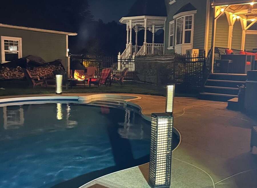 Enjoy evenings by the pool in this stunning property! This home features a beautiful outdoor space with a cozy fire pit, perfect for entertaining.