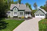 This charming property features a beautifully designed house with a detached garage, offering ample space and functionality.