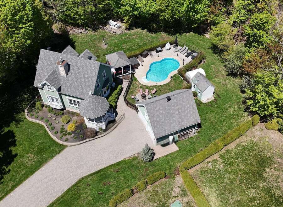 Discover your dream home with this stunning property featuring a private pool and lush landscaping.